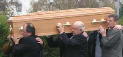 Relatives of Fr Con carrying his coffin in the cemetery